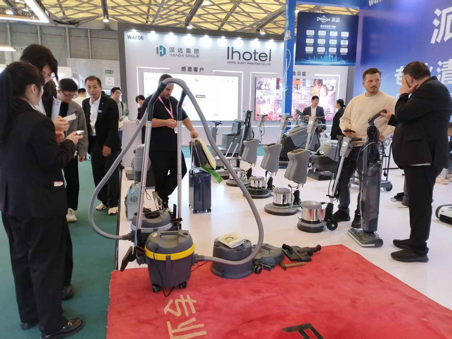 PADOM commercial cleaning equipment booth showcasing vacuum cleaners, floor scrubbers, single disc machines, and professional cleaning solutions at an exhibition.