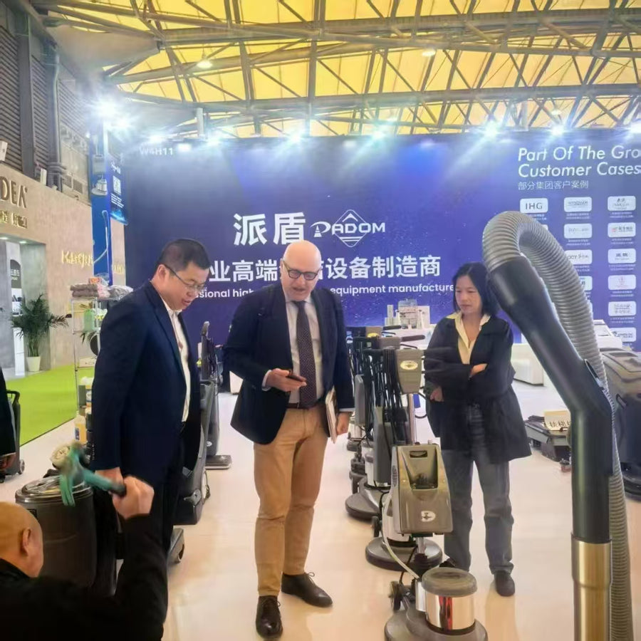 PADOM commercial cleaning equipment exhibition booth showcasing floor machines, vacuum cleaners, and professional cleaning equipment to international customers.