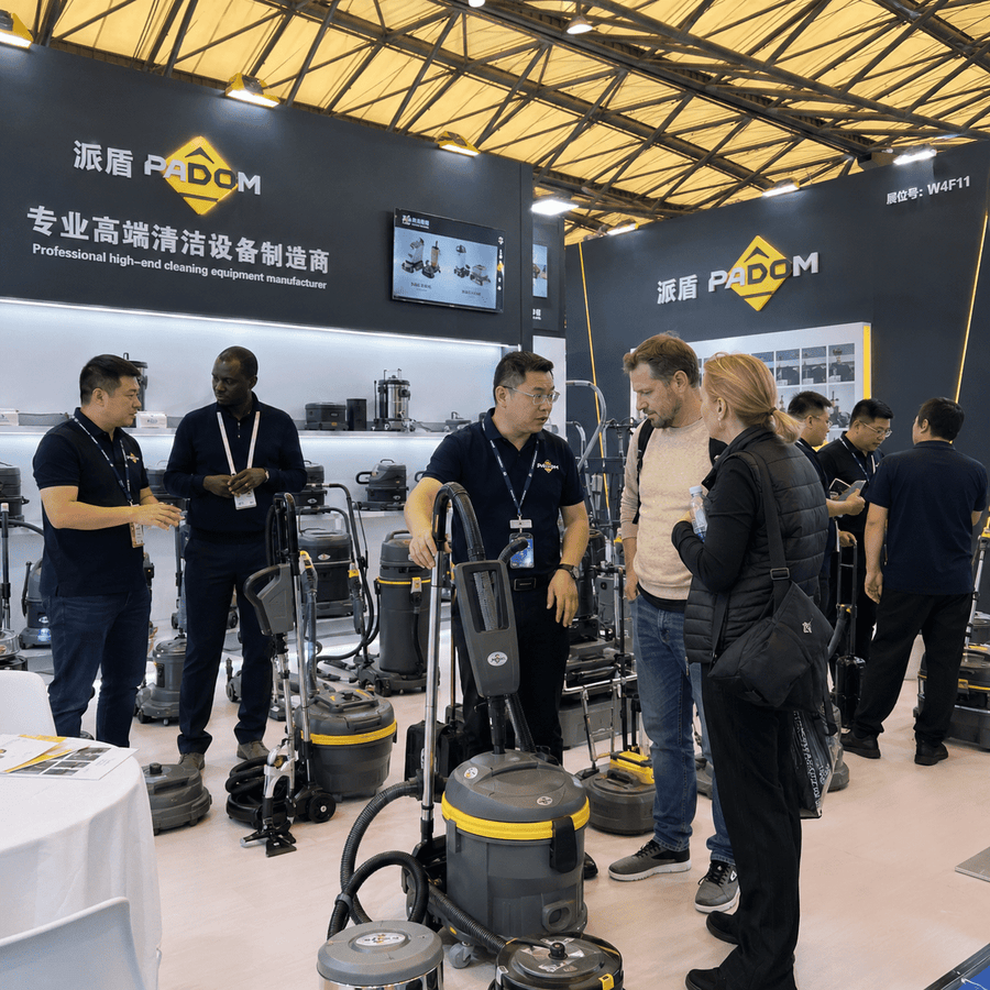 Staff members introduce cleaning equipment to customers at a cleaning equipment manufacturer's exhibition.